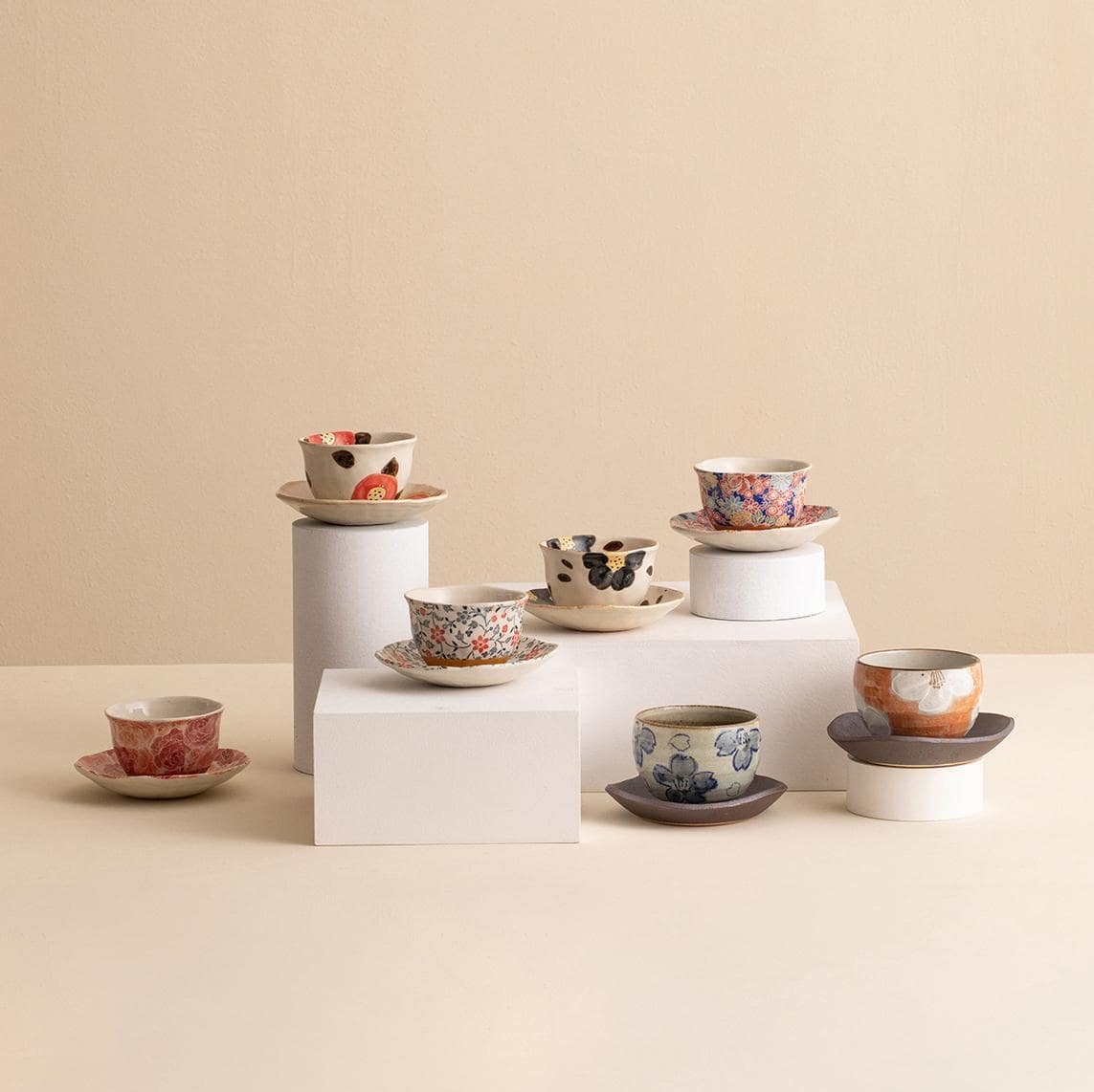 Floral ceramic cup with matching saucer on display