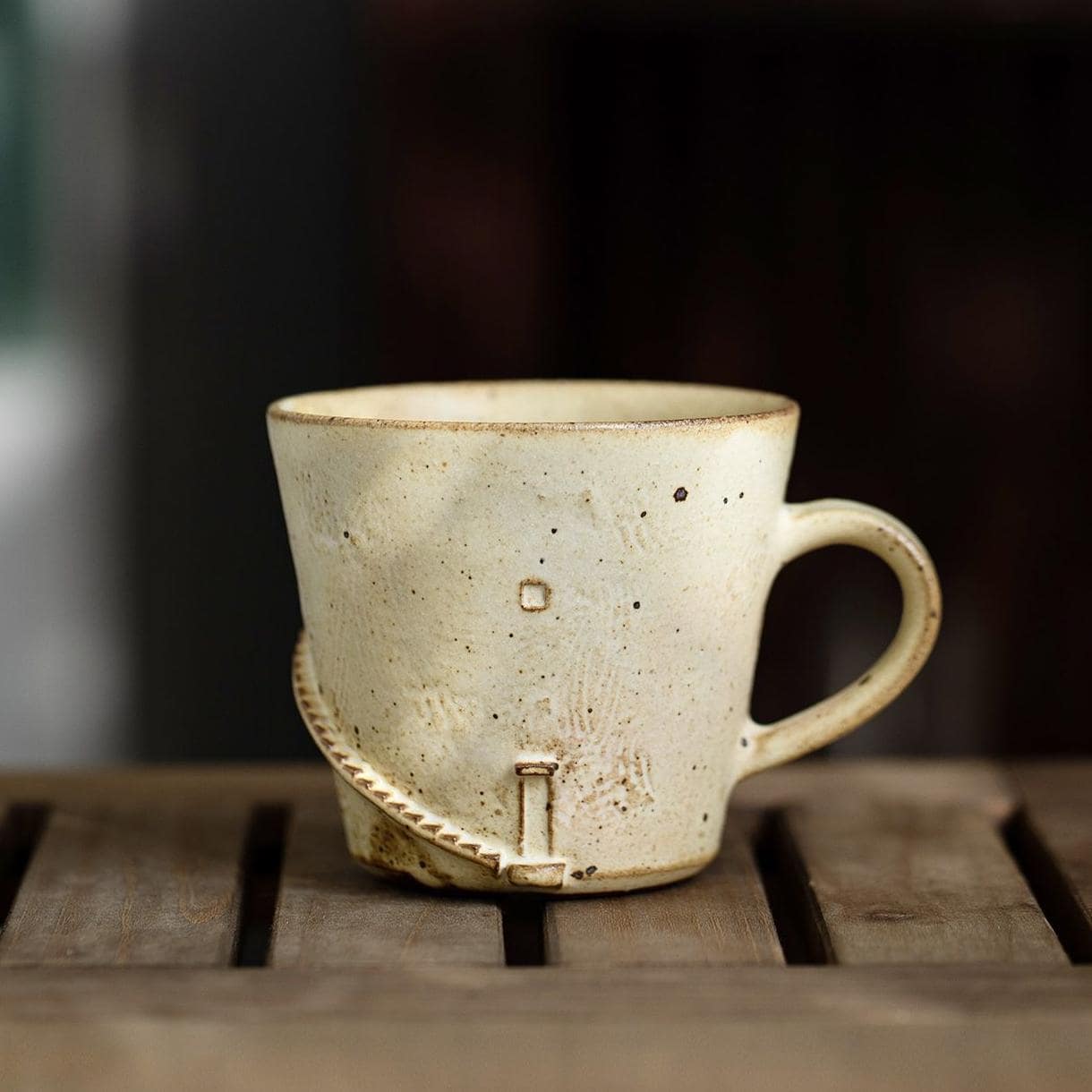 Handmade artisan mug on a wooden table.