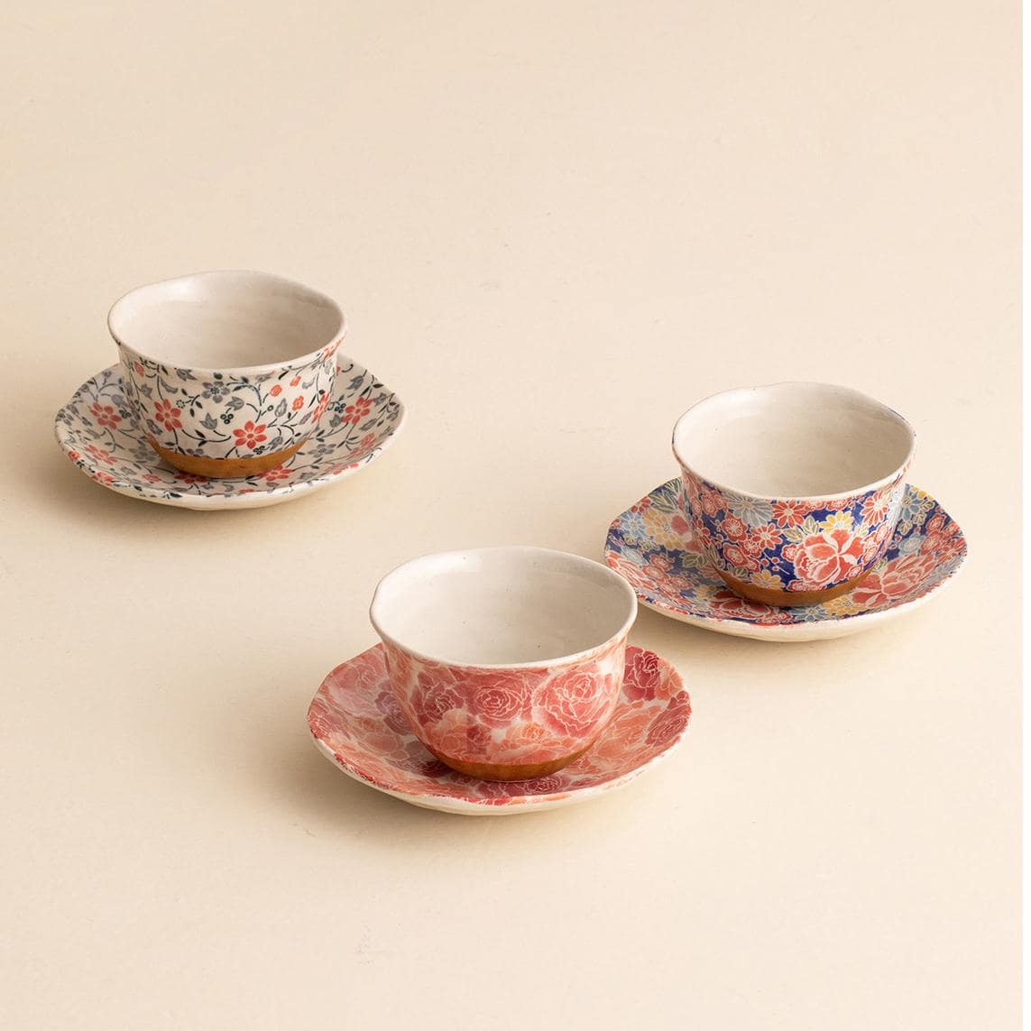 Handcrafted Japanese ceramic cup and saucer with floral patterns