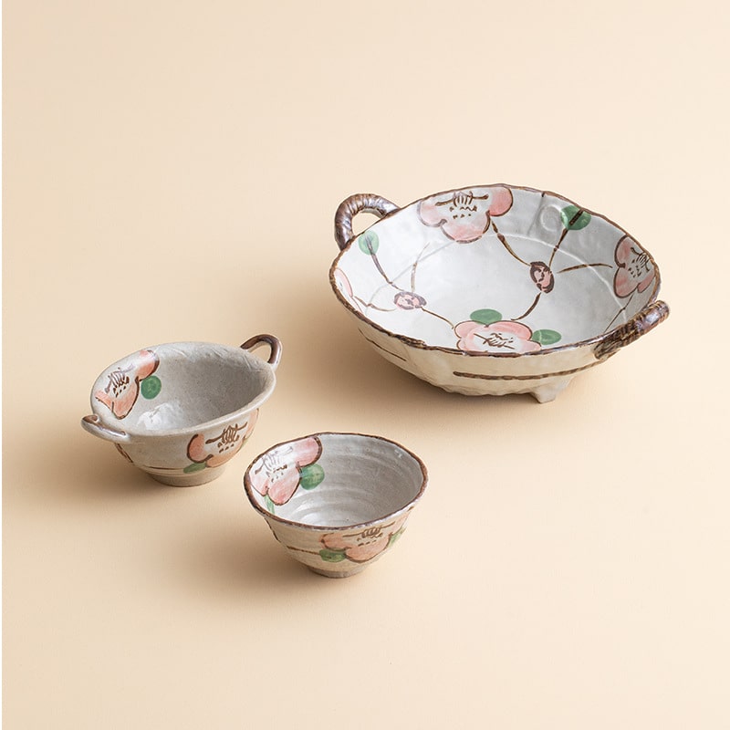 Artisan ceramic bowl set featuring traditional Japanese floral patterns.