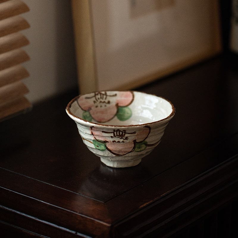 Rustic handcrafted serving bowl with earthy tones and side handles.