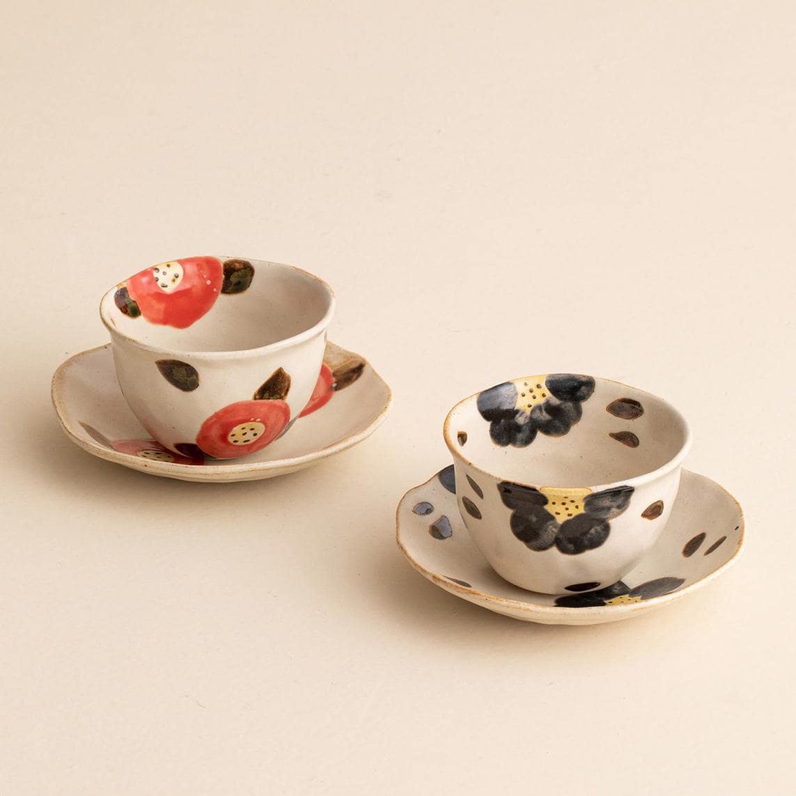 Artistic cup and saucer featuring a vibrant cherry blossom motif