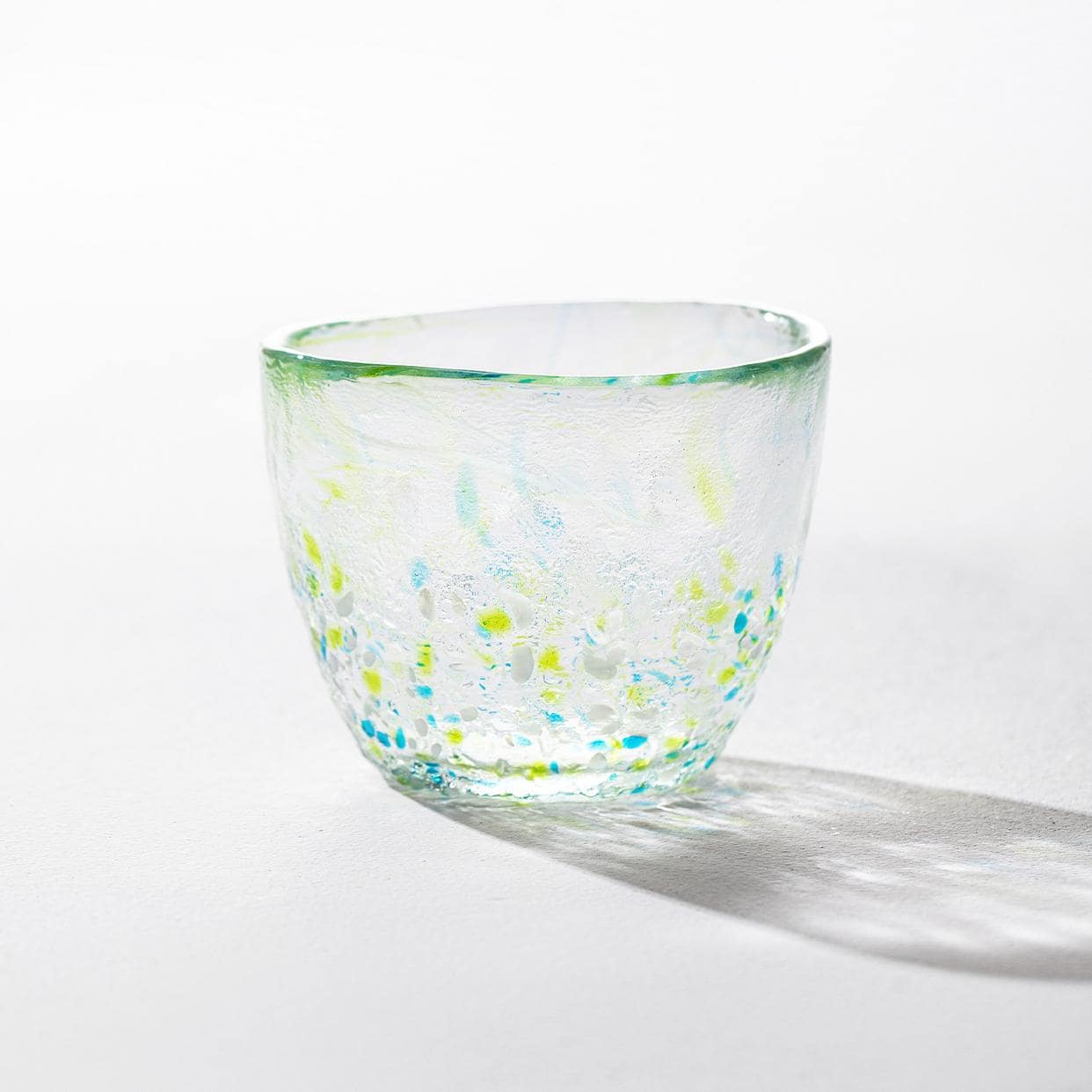 Pair of artisan glass cups featuring elegant multicolored designs.