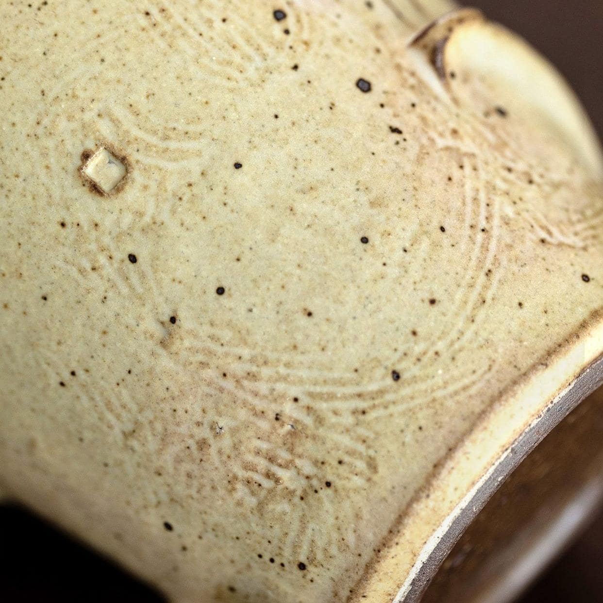 Close-up of handcrafted rustic coffee mug.