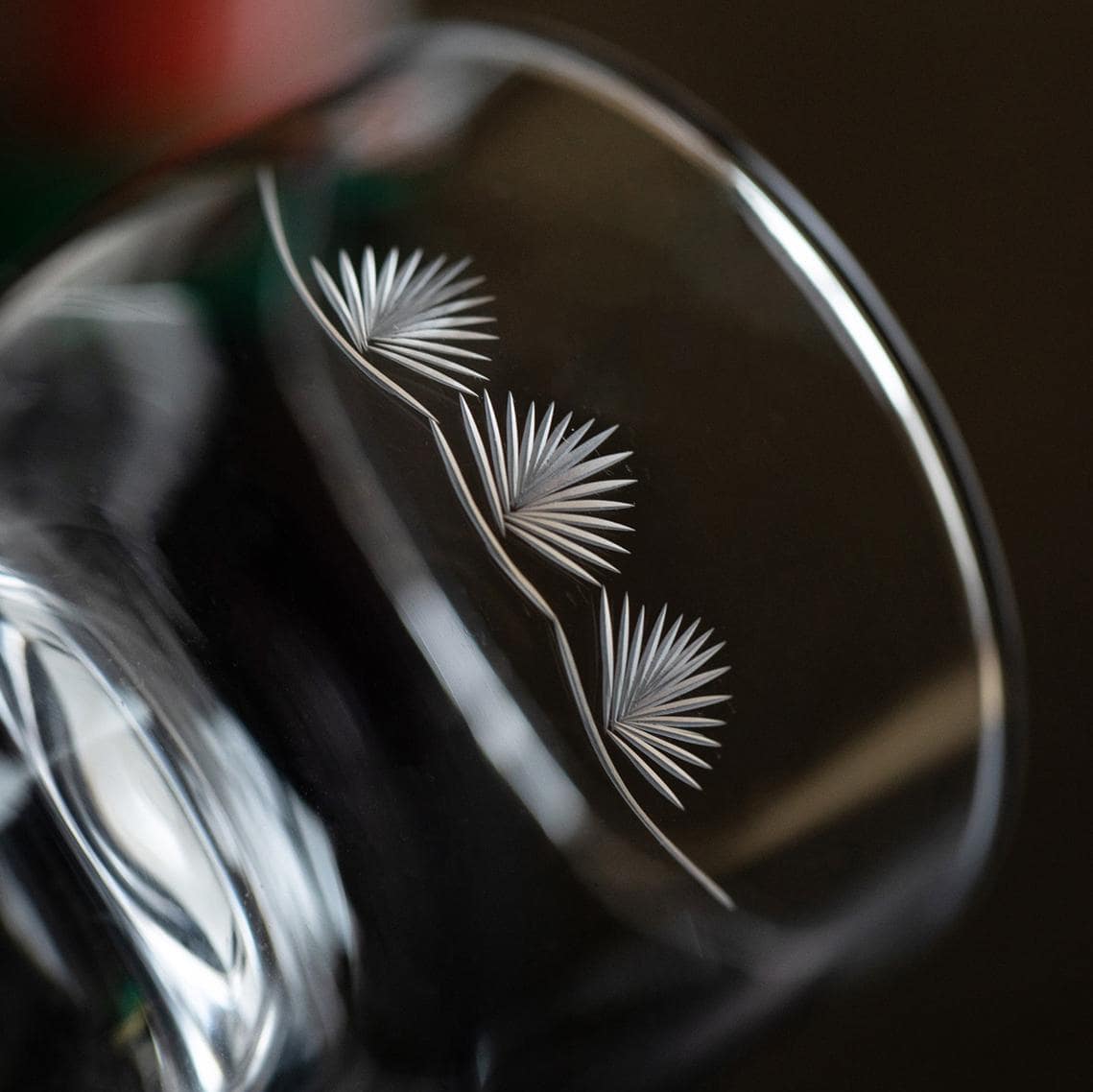 Close-up of floral etched pattern on crystal wine glass