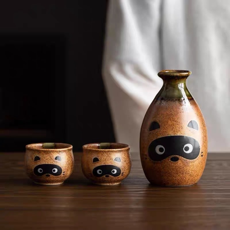 Raccoon-themed ceramic sake set with a rustic brown finish.
