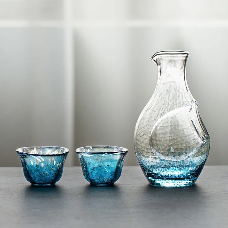 Elegant glass sake set with a blue gradient and hammered texture.
