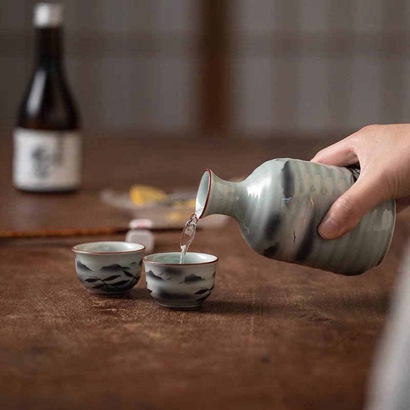 Artistic sake drinking set featuring traditional Japanese motifs.
