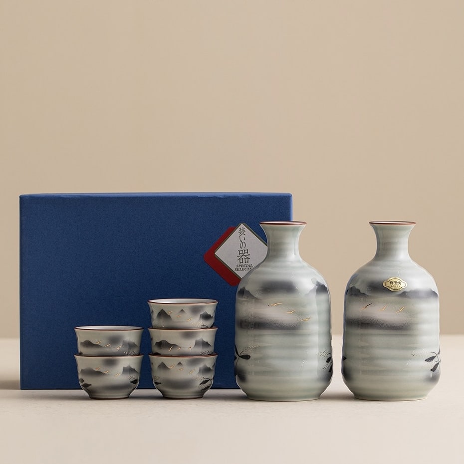 Ceramic sake set with hand-painted mountain and landscape designs.
