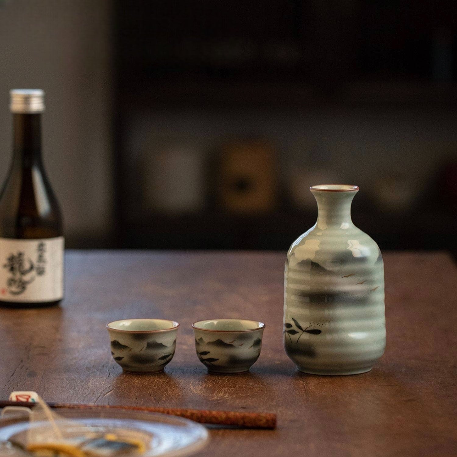 Close-up of hand-painted ceramic cups with mountain-inspired brushstrokes.
