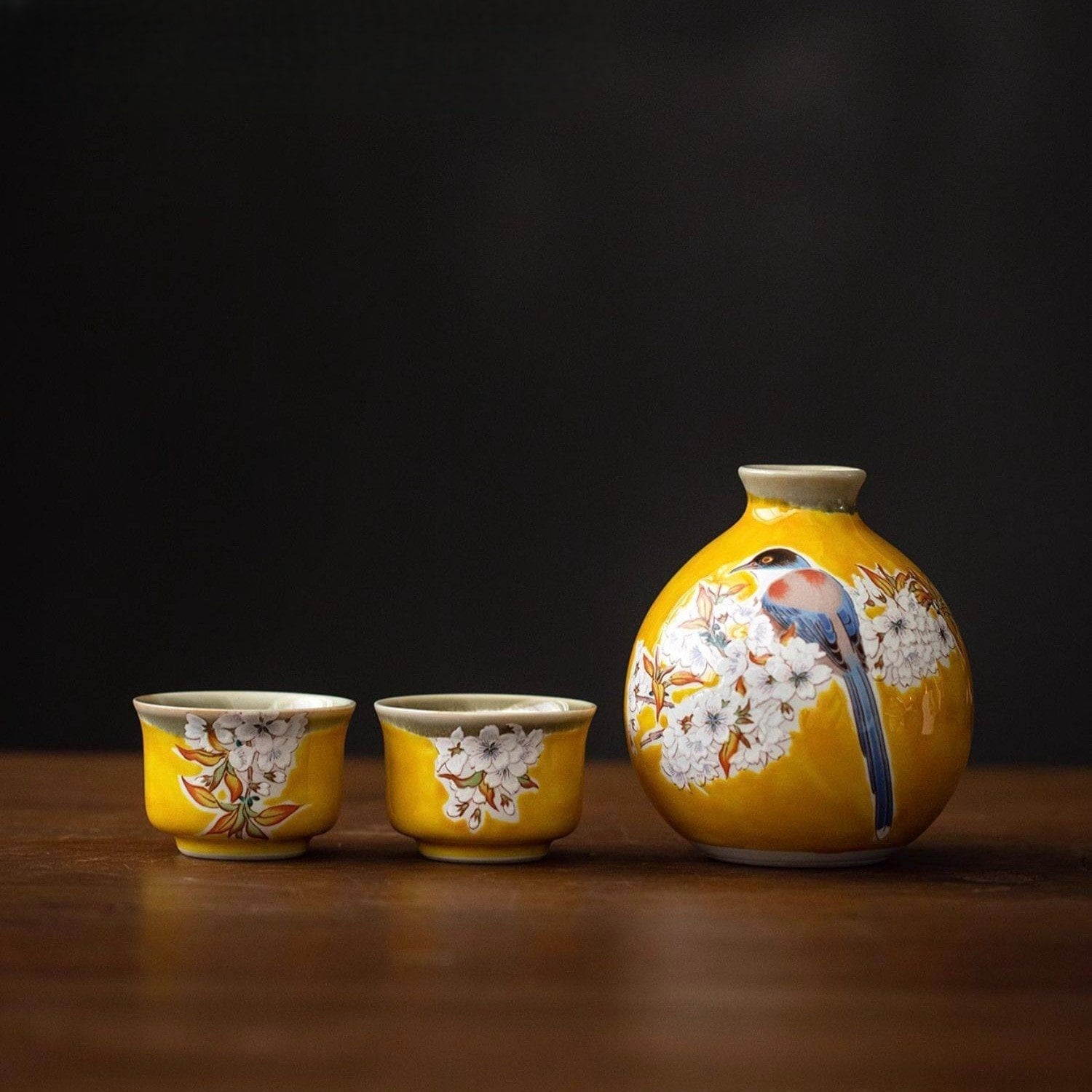 Elegant nature-inspired sake set displayed on a wooden table.
