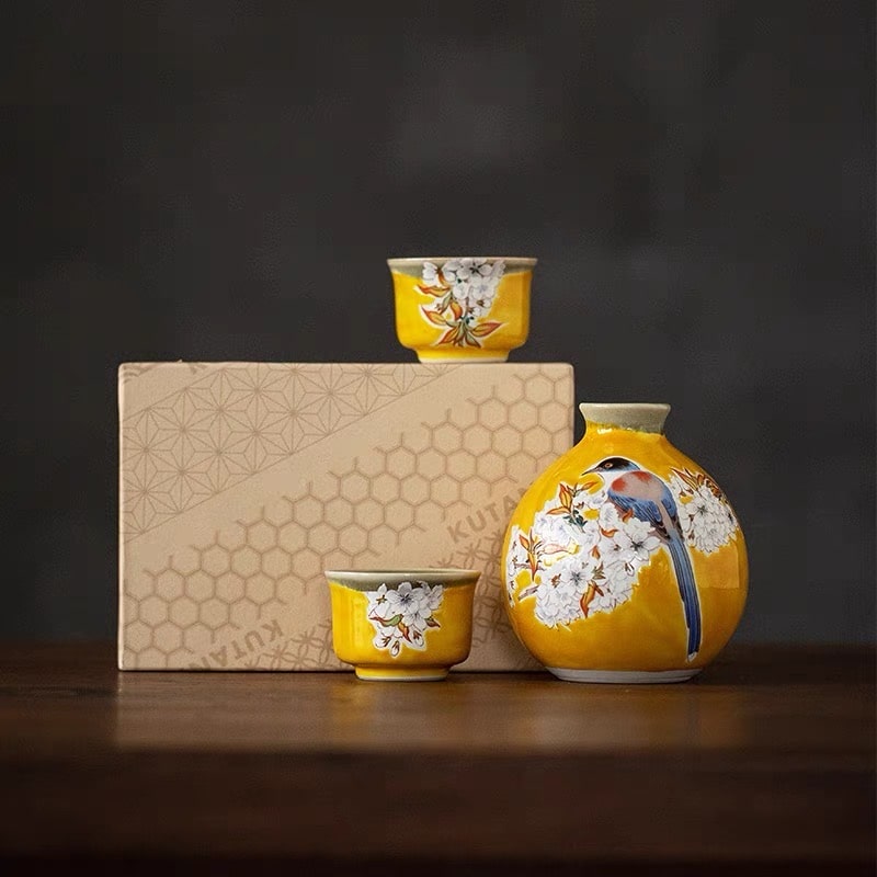 Artistic sake set with a bright yellow glaze and floral accents.
