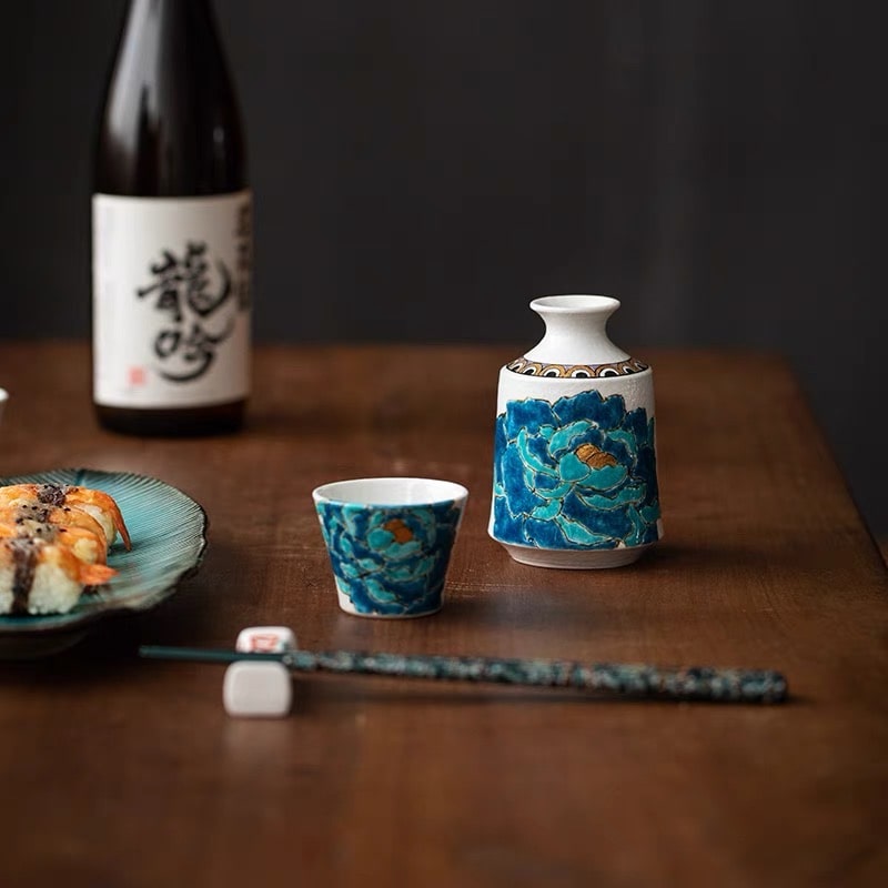 Close-up of blue peony design on ceramic sake cups.
