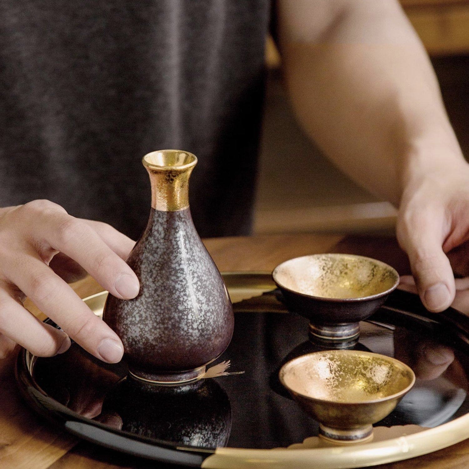 Elegant Japanese sake drinking set displayed on a lacquered tray.
