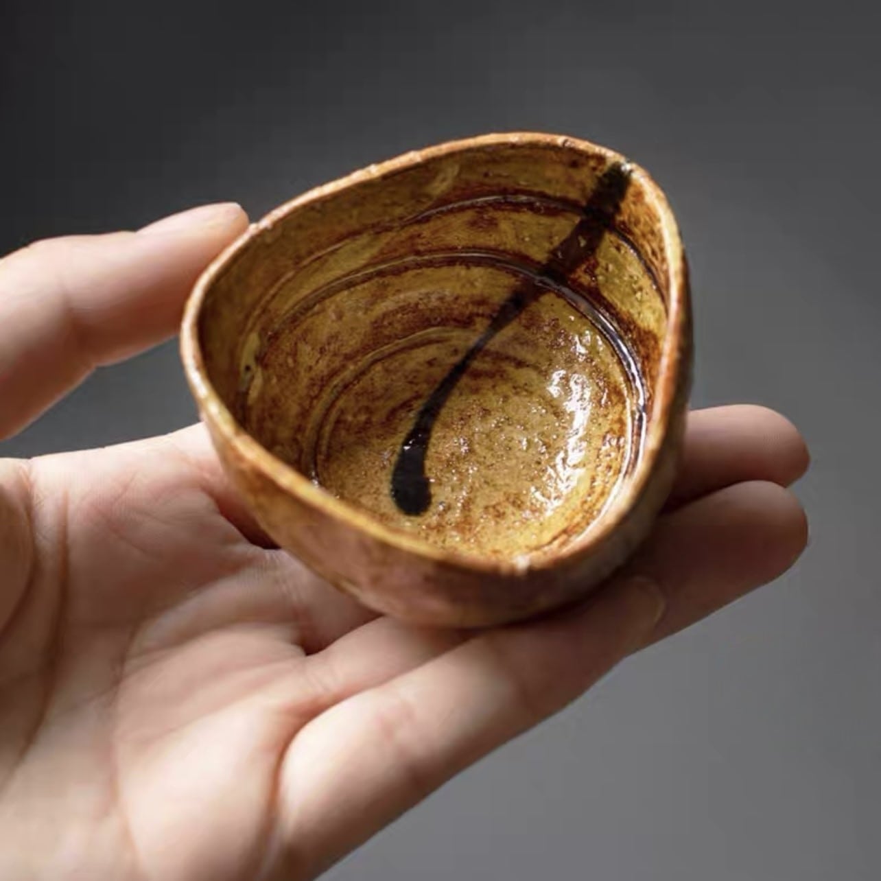 Artistic sake cup collection embracing the Wabi-Sabi aesthetic.
