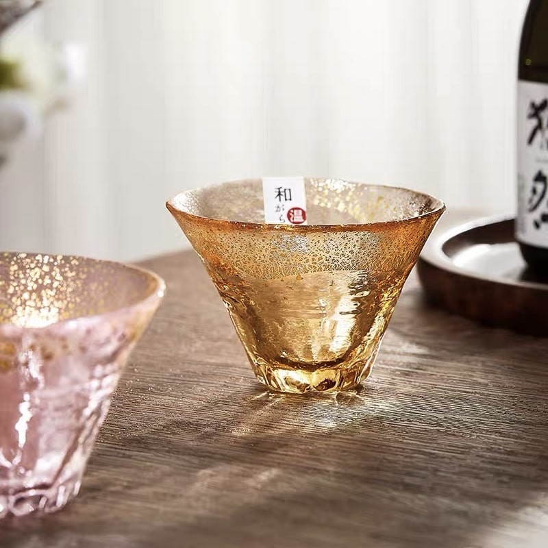 Artistic glass sake cups in various colors reflecting Mount Fuji’s design.
