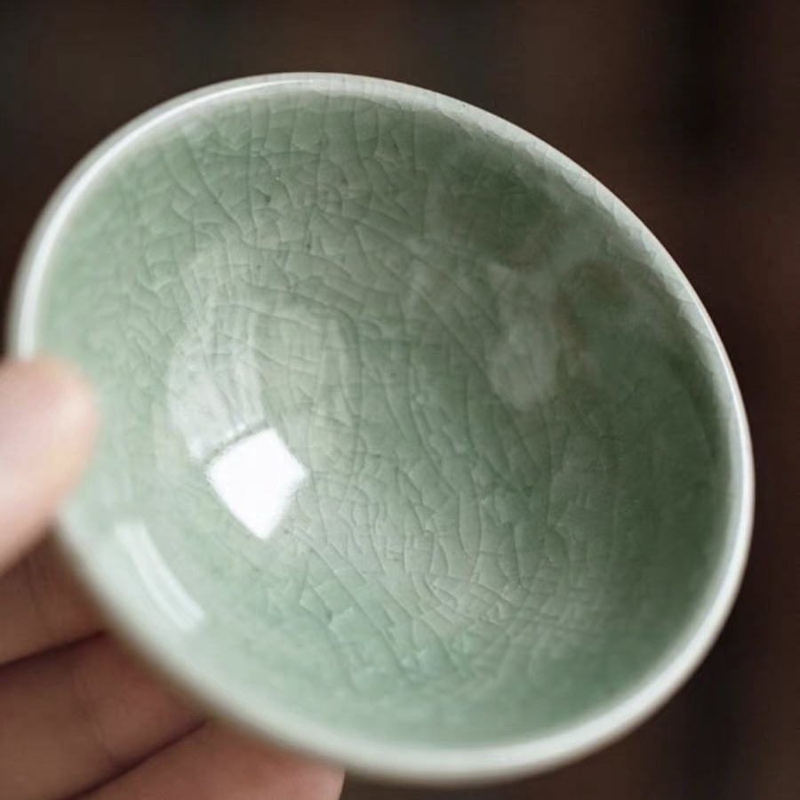 Close-up of handcrafted ceramic sake cups with varied textures.
