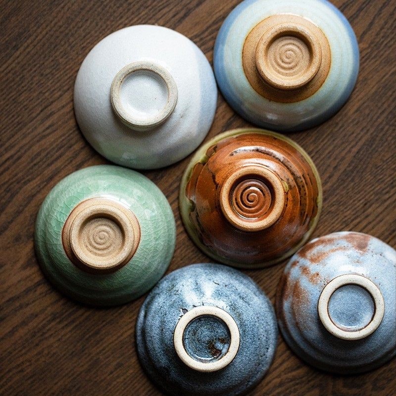 Artisan sake cup set displayed in a traditional wooden box.
