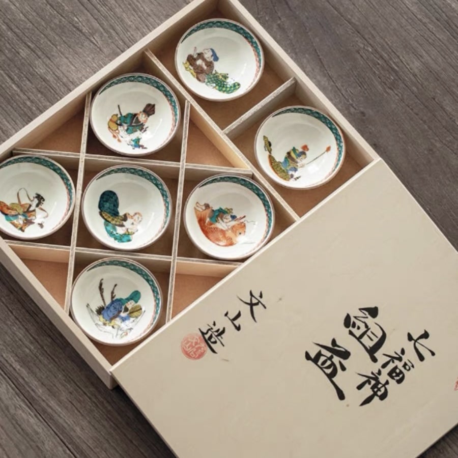 Hand-painted Japanese tea cup set with folklore designs in a wooden gift box.
