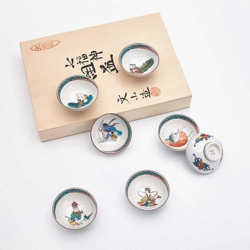 Hand-painted Japanese sake set with seven cups and a wooden gift box.
