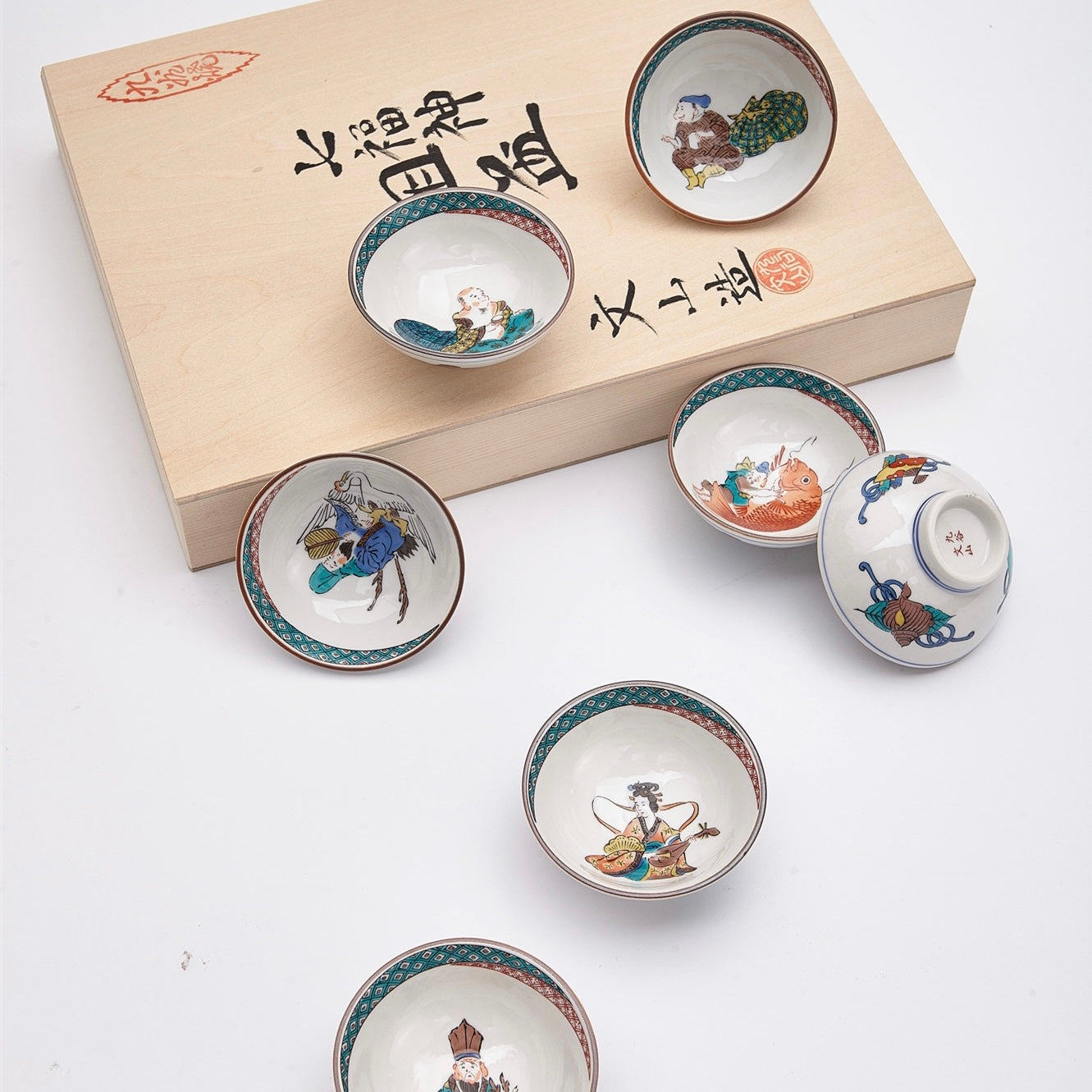 Hand-painted Japanese sake set with seven cups and a wooden gift box.
