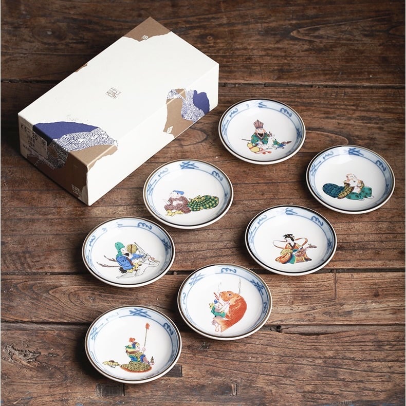 Hand-painted Japanese tea cup set with folklore designs in a wooden gift box.
