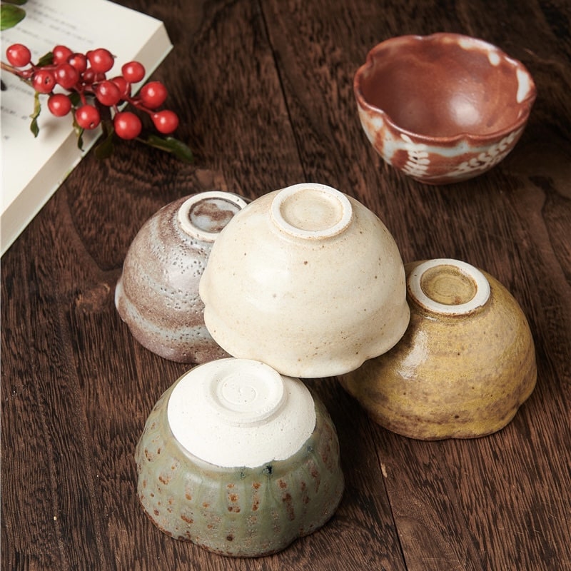 Close-up of delicate ceramic tea bowls with earthy tones and natural glazes.
