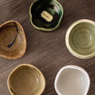 Handcrafted ceramic tea cups with unique shapes and natural glazes.
