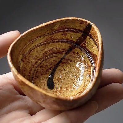 Japanese-style ceramic tea cups in a rustic design.
