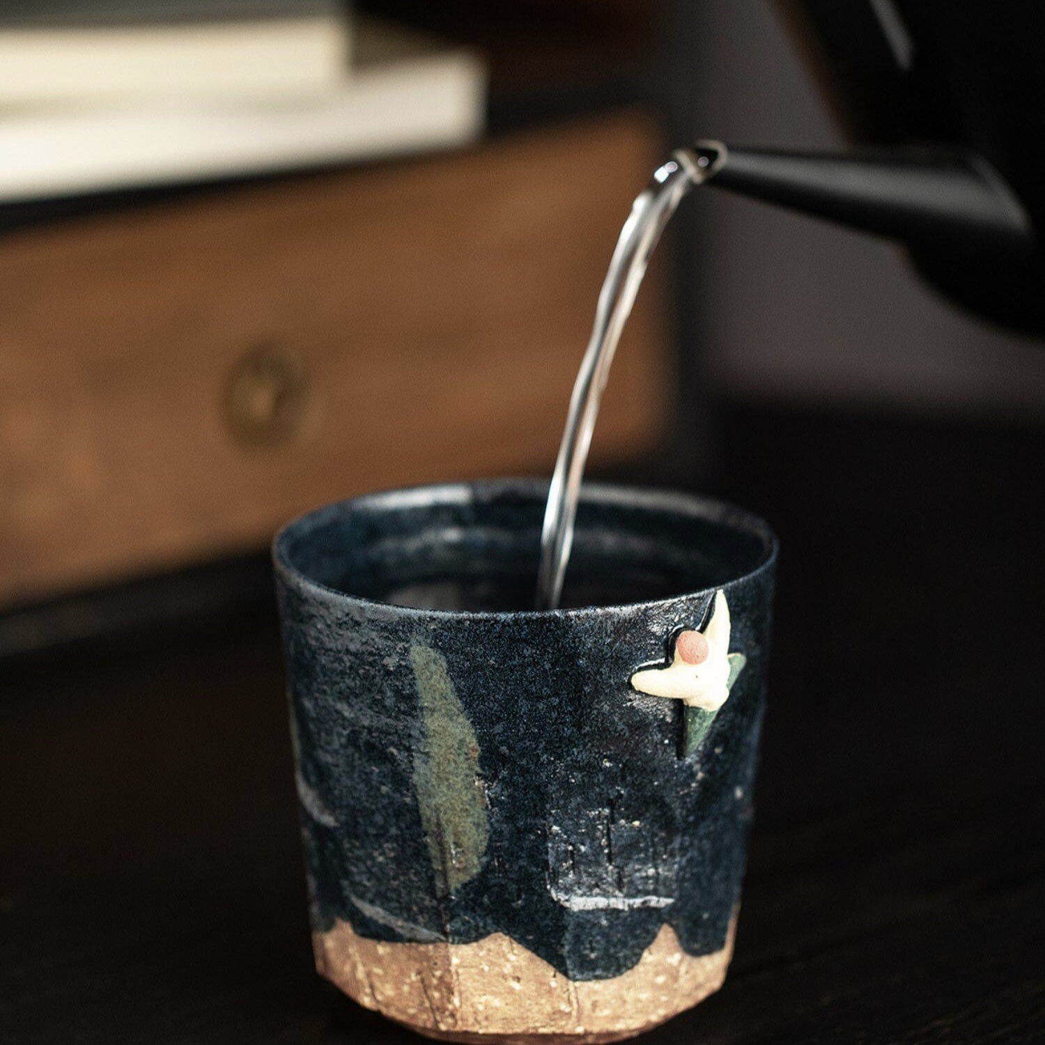 Handcrafted Japanese tea cup with midnight glaze and star motif