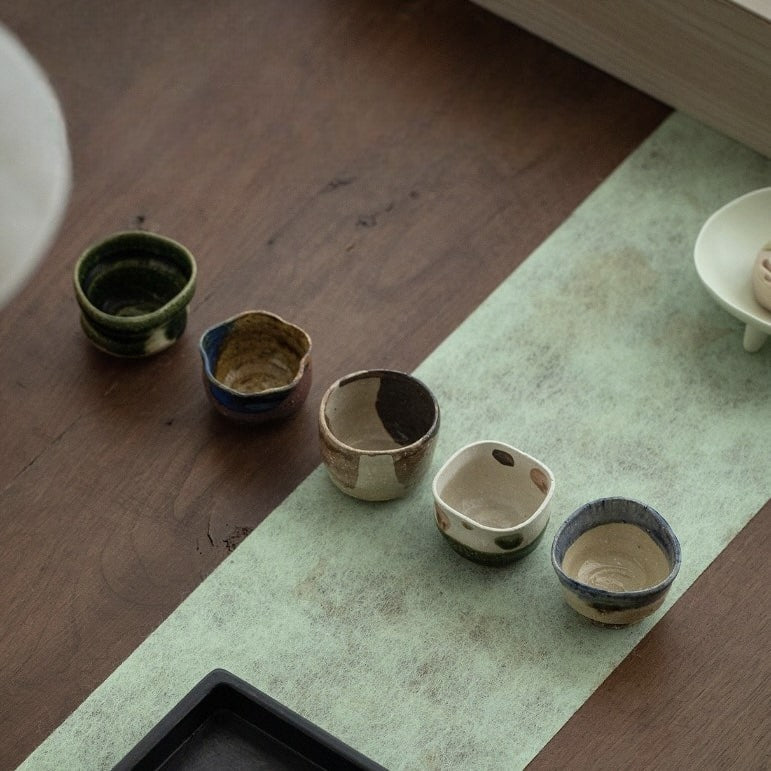 Set of unique Japanese-inspired ceramic tea cups.
