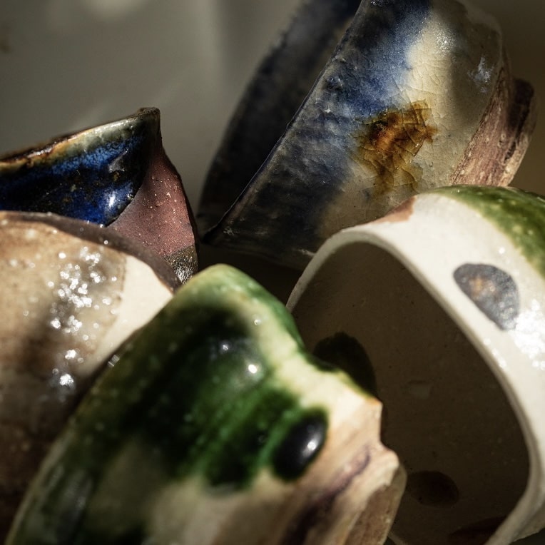 Artistic ceramic tea cup collection with textured designs.
