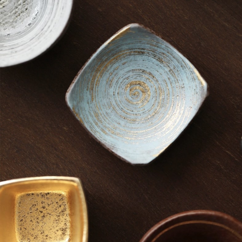 Premium ceramic sake cups with various designs and finishes.
