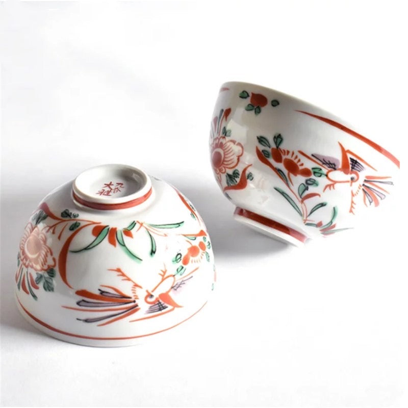 Hand-painted porcelain rice bowls with crane and floral designs.