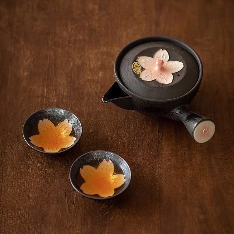 Wooden gift box with Japanese calligraphy and ceramic tea set featuring sakura flower designs.