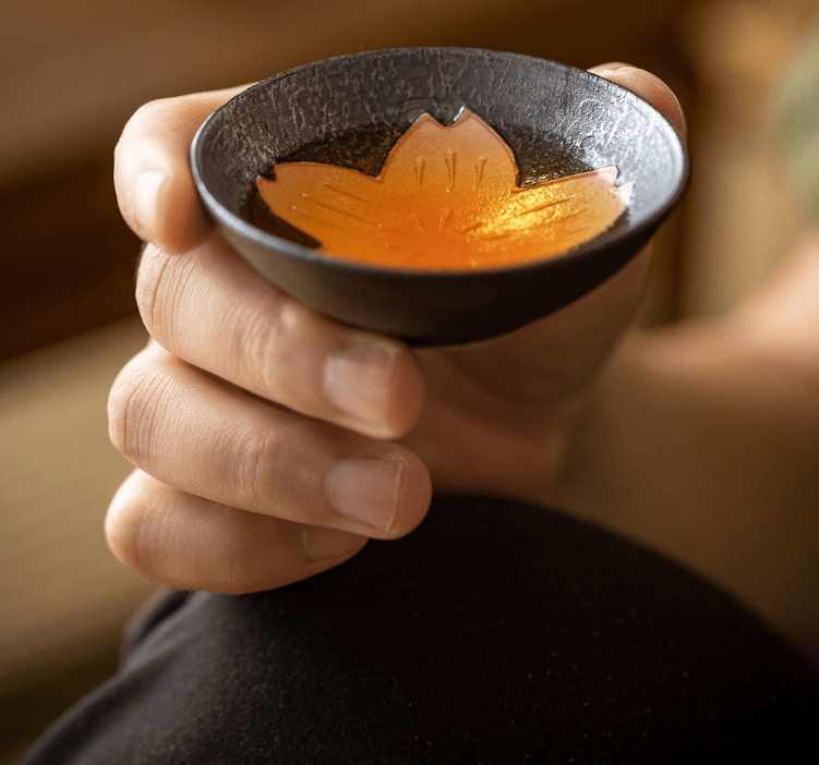 Close-up of cherry blossom design on handcrafted Japanese teacups.