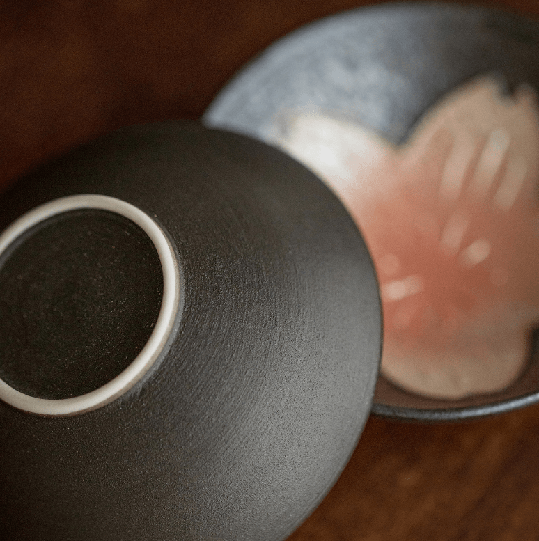 Traditional Japanese ceramic tea set with cherry blossom accents and decorative cards.