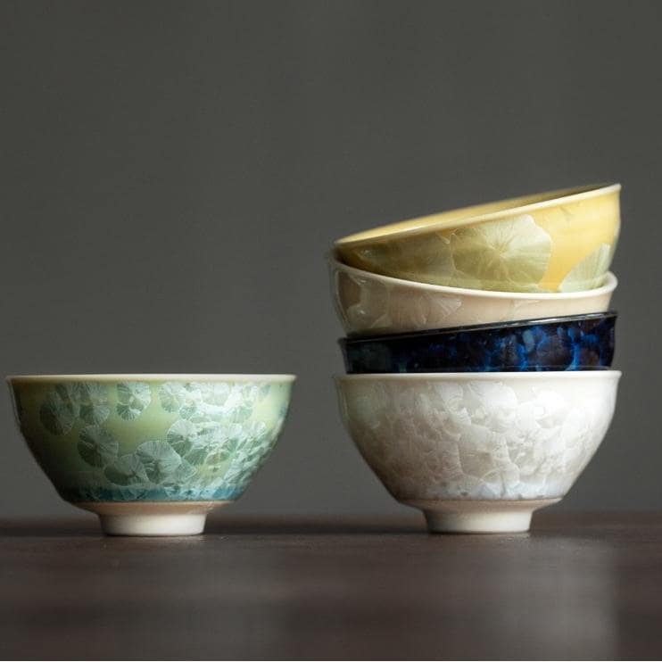 Handcrafted tea cups in nature-inspired colors, perfect for tea lovers.