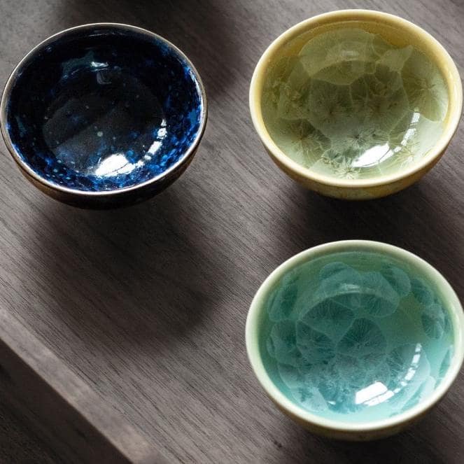 Artisan-crafted crackle glaze tea cups elegantly arranged for serving tea.