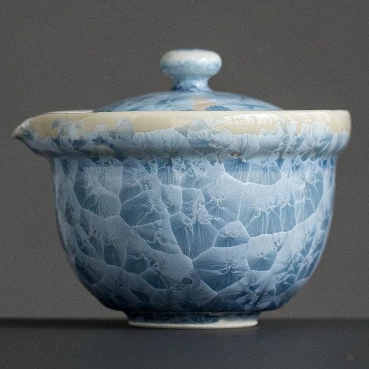 Artisan-crafted tea cups showcasing unique crackle finish in blue and white.