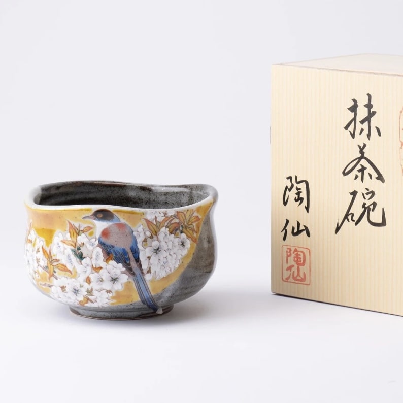 Handcrafted Japanese tea cup with bird and cherry blossom design