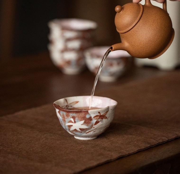 Elegant ceramic tea cups on a wooden table