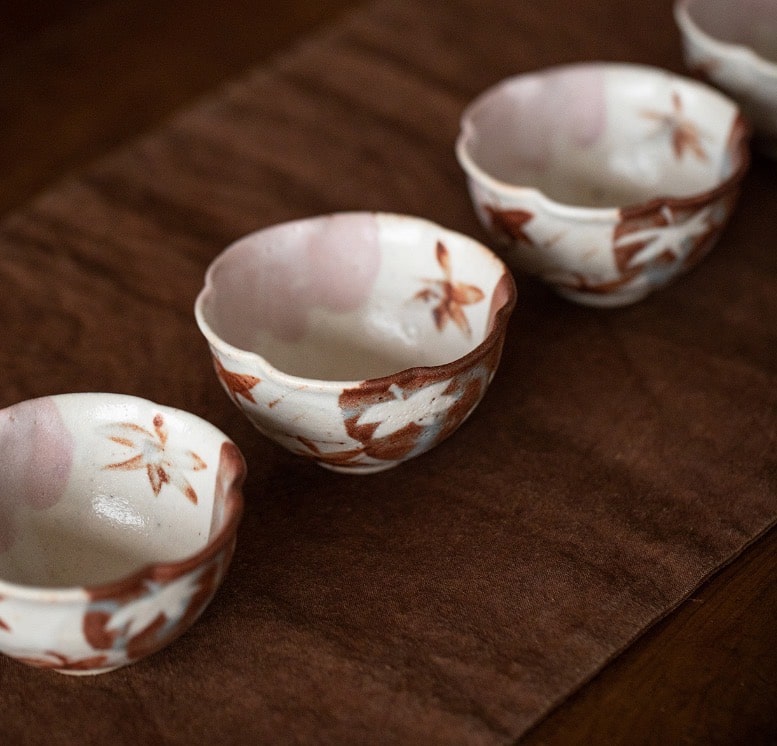 Close-up of scalloped ceramic tea cups