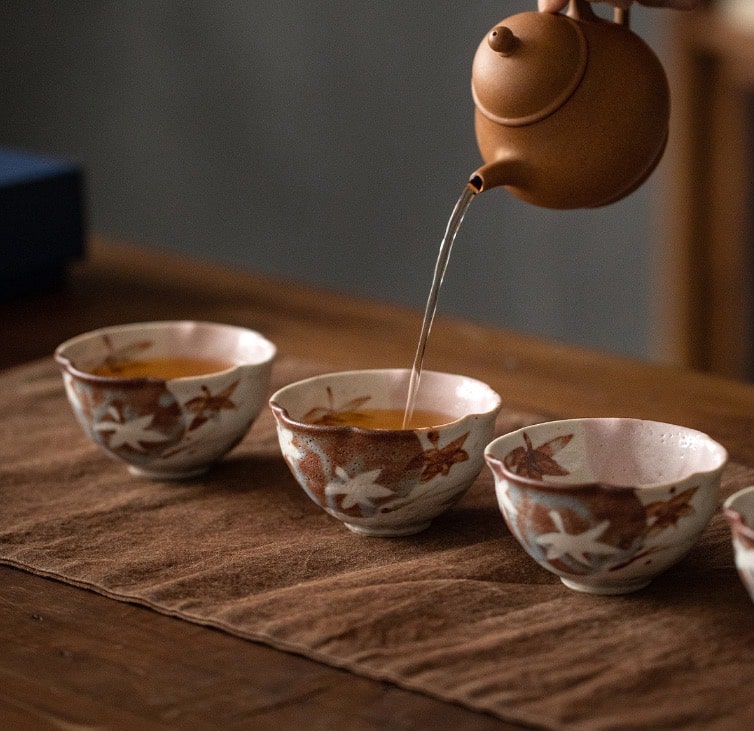 Set of artisanal tea cups with floral designs