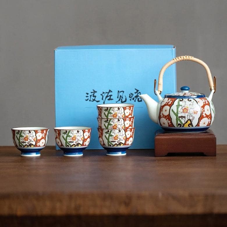 Hand-painted teapot and matching tea cups on display