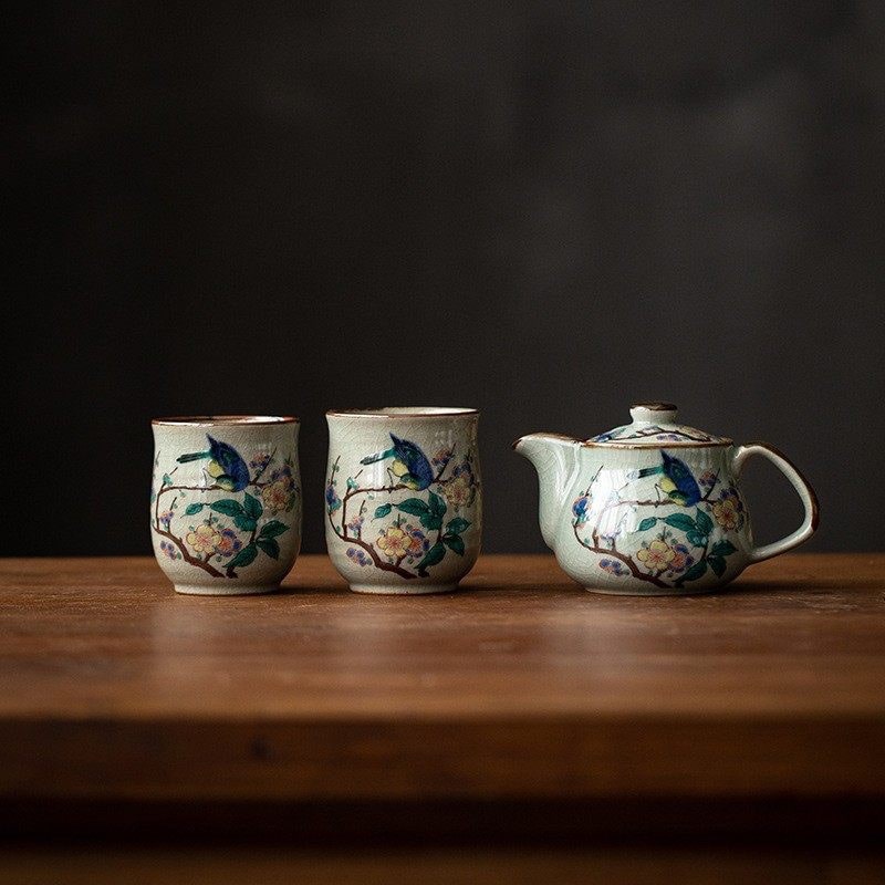 Vibrant floral teapot and matching cups on display