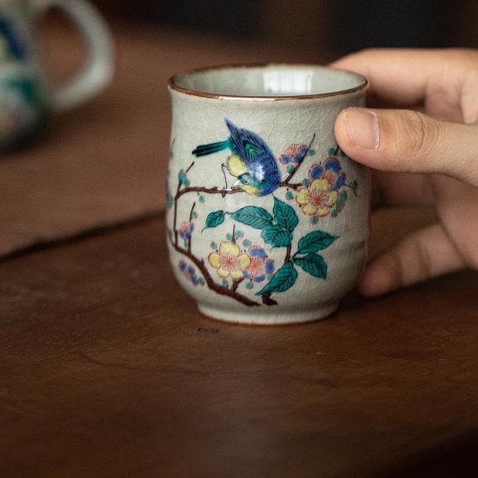 Close-up of intricate hand-painted floral tea set