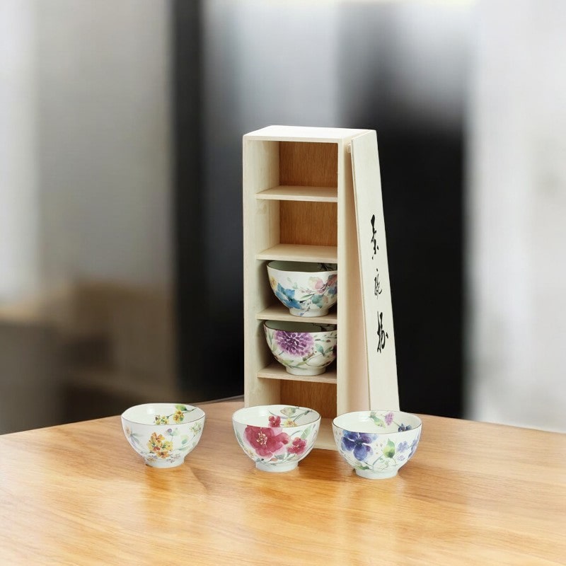 Beautifully crafted ceramic rice bowls displayed in a premium wooden box.