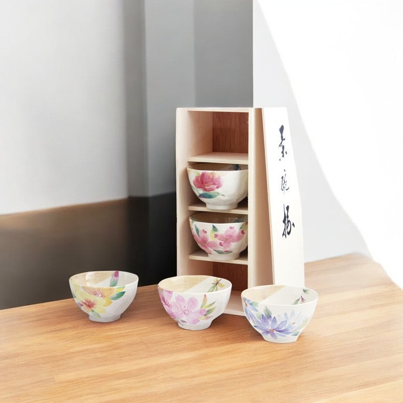 Artisan rice bowl set with unique hand-painted floral patterns.