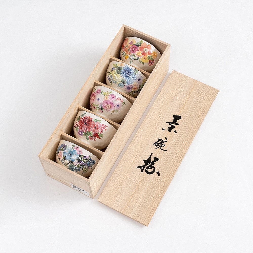 Beautifully crafted ceramic rice bowls displayed in a premium wooden box.